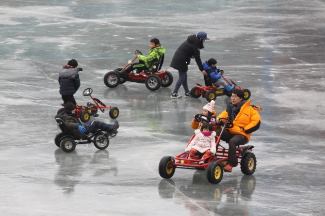 강원 화천에서 열린 산천어축제에 부모와 함께 축제장을 찾은 어린이들이 얼음놀이를 즐기고 있다./사진=뉴시스