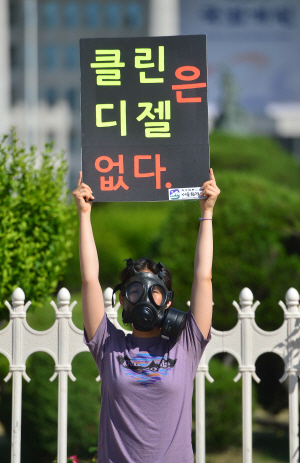 서울환경운동연합 회원이 국회 앞에서 20대 국회에 미세먼지 근본 대책을 촉구하는 ‘클린 디젤은 없다’ 캠페인을 전개하며 피켓시위를 하고 있다 / 사진=뉴시스