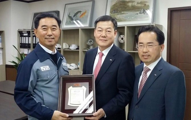 BNK경남은행 유충렬 본부장(사진 가운데)이 ㈜태진중공업 최태환 대표이사(사진 왼쪽)에게 파트너기업 인증패를 전달한 후 기념촬영하고 있다. /경남은행