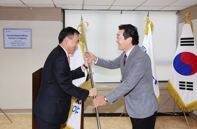 유경선 유진그룹 회장(오른쪽)이 이계천 유진저축은행 대표에게 깃발을 전달하고 있다.