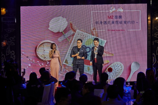 가수 더원과 개그맨 이승환이 중국 청도에서 M2 지퍼마스크팩 런칭 행사를 진행하고 있다. 