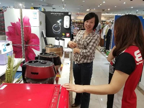 중국 상하이 징띵타샤 백화점 매장에서 대유위니아 '딤채쿡' 밥솥을 구경하고 있는 현지 소비자 모습. 사진=대우전자.  