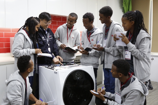 선발된 7명의 학생들이 LG 시그니처 세탁기를 수리하는 방법에 대해 설명을 듣고 있다.