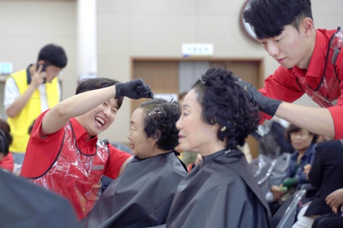 지난 25일 열린 '어르신과 함께하는 사랑 나눔 행사'에서 티웨이항공 객실승무원들이 인근 독거노인들의 머리를 염색하고 있다. 사진=티웨이항공
