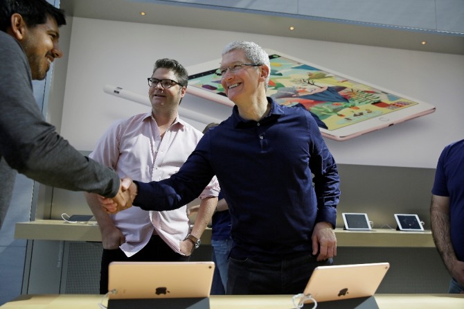 애플 CEO 팀 쿡이 고객과 악수를 나누고 있다.