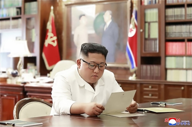 조선중앙통신이 23일 홈페이지에 공개한 사진에서 김정은 북한 국무위원장이 집무실로 보이는 공간에서 트럼프 대통령의 친서를 읽는 모습./연합뉴스 