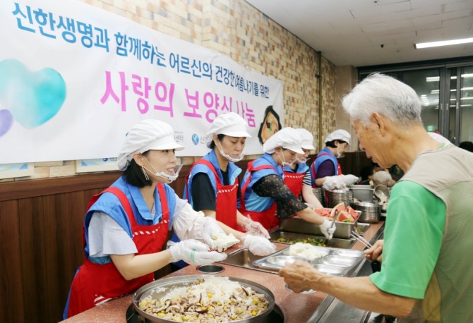 서울 양천어르신종합복지관에서 신한생명 직원봉사자가 보양식 배식을 하고 있는 모습./사진=신한생명