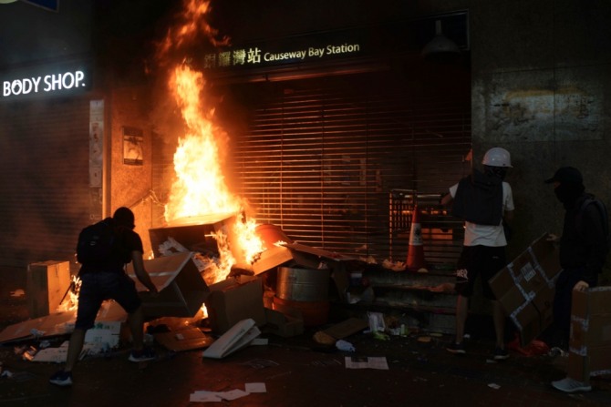 4일 저녁 홍콩 지하철 코즈웨이 베이역 입구에서 한 시위대들이 불을 지르고 있다. 사진=뉴시스