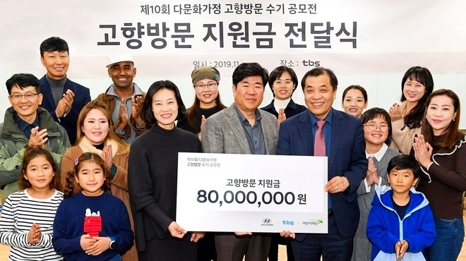 현대차 송성호(앞줄 오른쪽 세번째) 상무가 다문화가정에 고향 방문 지원금 8000만원을 전달하고 기념사진을 찍고 있다. 사진=현대차