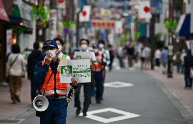일본 도쿄 공무원이 지난 4일 거리를 순찰하면서 시민들에게 신종 코로나바이러스 감염증(코로나19) 사태 속 집에 머물 것을 권고하고 있다.