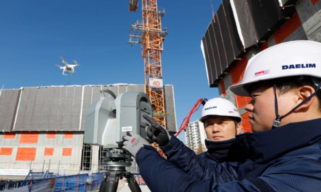 대림산업 직원들이 김포의 한 아파트 건설공사 현장에서 3D 스캐너와 드론을 활용해 BIM 설계에 필요한 측량자료를 촬영하고 있다. 사진=대림산업