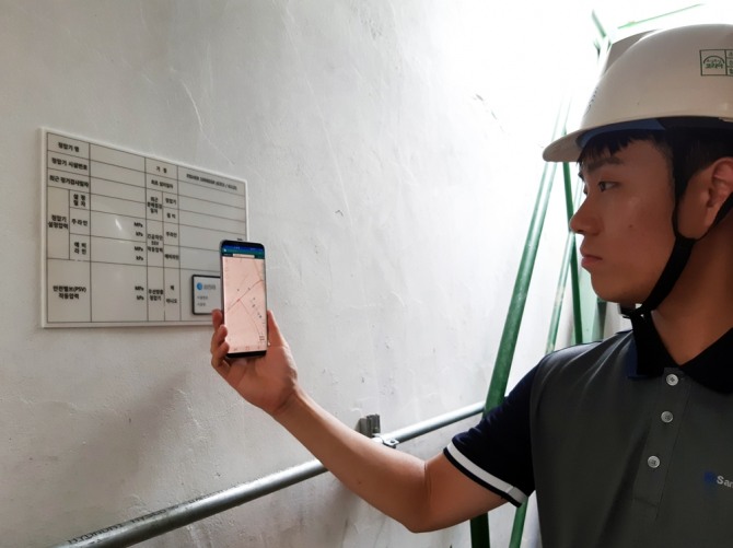 삼천리 현장 안전점검 담당자가 정압기실에 설치된 NFC 시스템을 업무에 활용하고 있다. 사진=삼천리