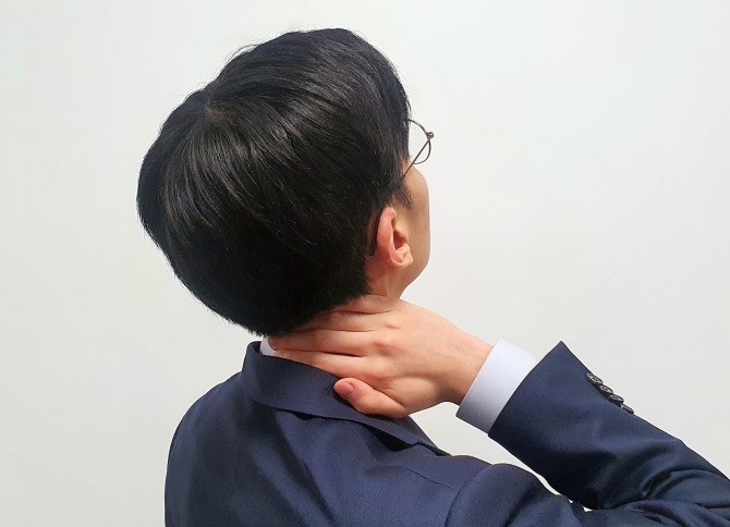 한 직장인이 목통증을 호소하고 있다. 사진=자생한방병원