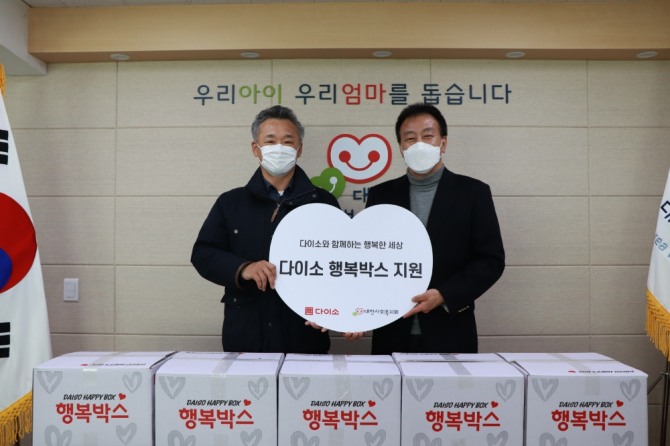 김백철 다이소 상무(왼쪽)와 김석현 대한사회복지회 회장이 행복박스 앞에서 포즈를 취하고 있다. 사진=애경산업