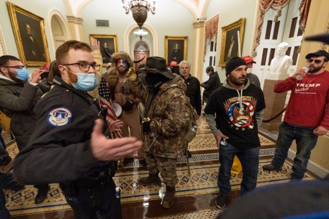 지난 6일(현지시간) 미 국회의사당에 난입한 도널드 트럼프 대통령의 지지자들이 상원 의원실 밖에서 국회 경비대와 대치하고 있다. 사진=AP/뉴시스