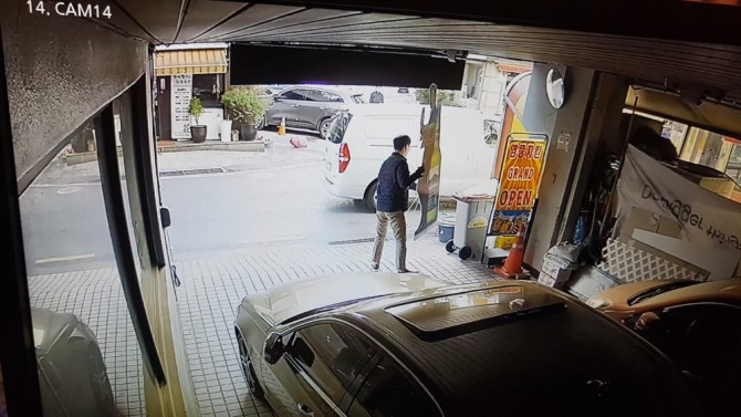 오비맥주가 입수해 경찰에 증거로 제출한 CCTV 영상 일부. 누군가 식당 앞에 승합차를 세운 뒤 '한맥' 입간판을 무단으로 수거해 트렁크에 싣고 있다.