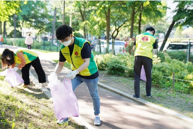 걸음 기부 캠페인에 참여한 롯데건설 직원들이 걸으면서 길가에 버려진 쓰레기를 청소하는 '줍깅 챌린지' 활동을 하고 있다. 사진=롯데건설