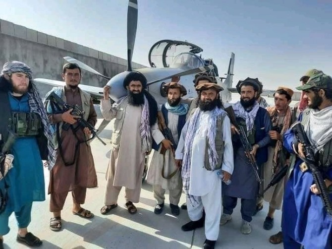 탙레반 병사들이 미국이 아프가니스탄 정부군에 제공한 수퍼투카노 전투기 앞에서 포즈를 취하고 있다.사진=알딘 트위터