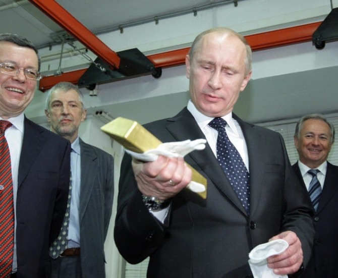 블라디미르 푸틴 러시아 대통령이 러시아 중앙은행 금 보관소에서 금을 만져보고 있다. 사진=AFP
