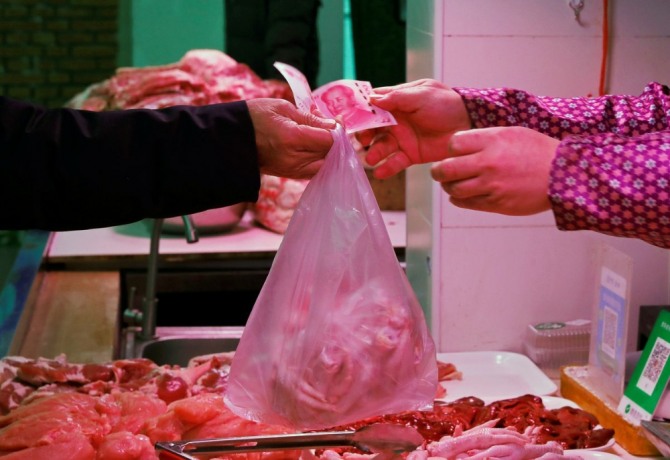 지난해 1월 베이징 시민이 시장에서 고기를 구매하고 있다. 사진=로이터