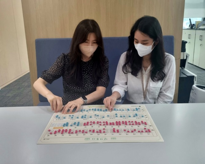 CJ온스타일 임직원들이 시각장애인의 글자 학습을 위해 고안된 교구인 점자벽보를 직접 제작하고 있다. 사진=CJ온스타일