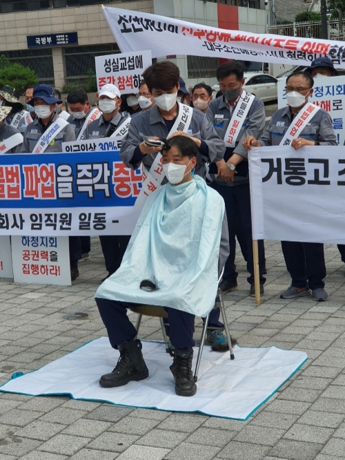 11일 오후 2시 대우조선해양 협력업체협외회 회원사 대표들과 함께 서울 용산 전쟁기념관 앞에서 진행한 하청 지회 불법파업 해결 촉구 집회에 참석한 인민용 ㈜삼주 대표가 동료의 도움을 받아 삭발을 하고 있다. 사진=대우조선해양