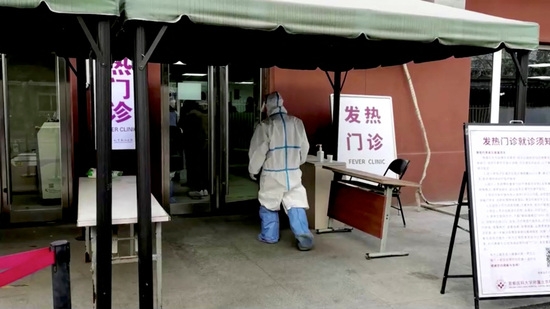 보호복을 입은 직원이 중국 베이징의 열병 진료소로 걸어 들어가고 있다. 사진=로이터