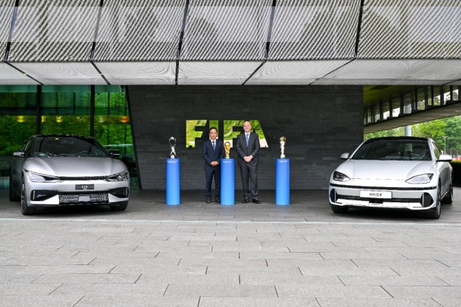 현대차그룹 기획조정실장 김걸 사장(왼쪽)과 지안니 인판티노(Gianni Infantino) FIFA 회장(오른쪽)이 조인식 이후 아이오닉 6, EV6 옆에서 기념 촬영을 하고 있다. 사진=현대자동차그룹