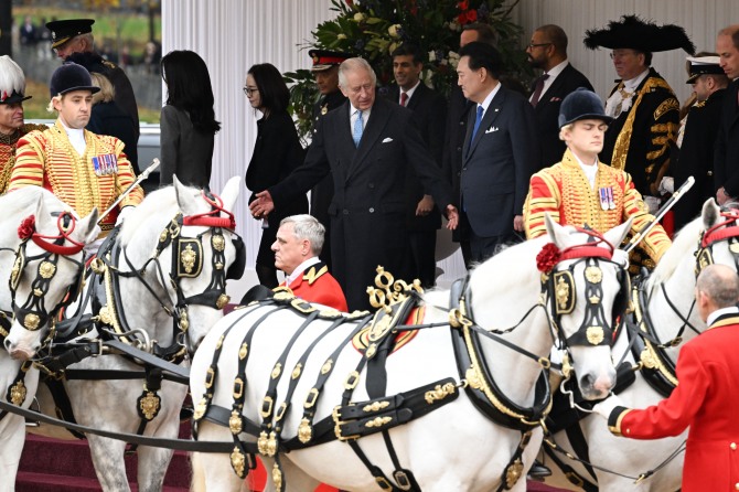 영국을 국빈방문 중인 윤석열 대통령이 21일(현지시간) 찰스 3세 국왕과 함께 마차를 타고 런던 버킹엄궁으로 향하기 위해 이동하고 있다. 사진=뉴시스