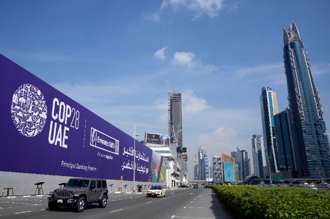 27일(현지시간) 아랍에미리트(UAE) 두바이의 셰이크자이드 고속도로에서 자동차들이 제28차 유엔기후변화협약 당사국 총회(COP28) 광고판을 지나치고 있다. 사진=연합뉴스.