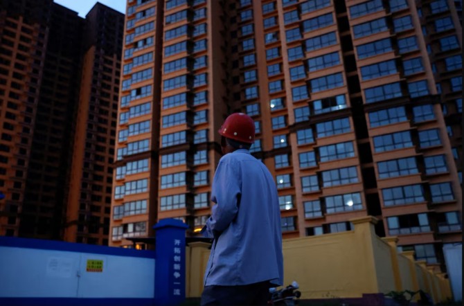 산시성 퉁촨시에서 한 구매자가 아직 완공되지 않은 아파트를 바라보고 있다. 사진=로이터