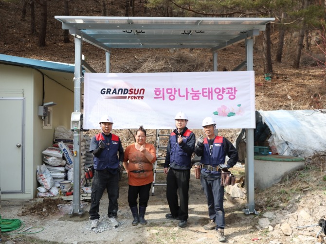 그랜드썬봉사단이 희망나눔태양광 설치를 완료하고 주민과 함께 기념촬영을 하고 있다.  사진=그랜드썬봉사단