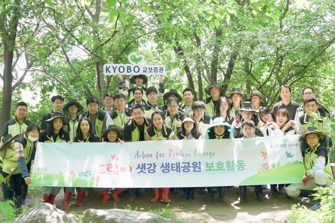교보증권 임직원들이 22일 여의샛강생태공원에서 ‘어린나무 살리기’ 사회공헌활동을 실시하고 기념촬영을 하고 있다.  사진=교보증권