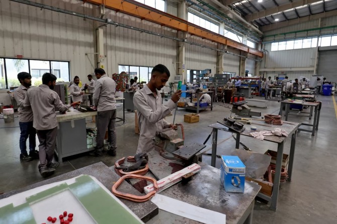 인도 아마다바드 외곽에 위치한 사난드 GIDC(구자라트 산업개발공사)에 있는 인닥타썸(인도) 프라이빗 리미티드의 제조 유닛에서 직원들이 전기 변압기를 조립하고 있다. 사진=로이터