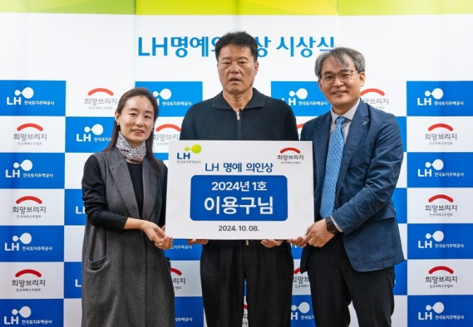 LH 명예 의인으로 선정된 이용구씨(가운데)와 희망브리지 관계자, LH 관계자가 시상식 진행 후 기념촬영을 하고 있다. /사진=희망브리지