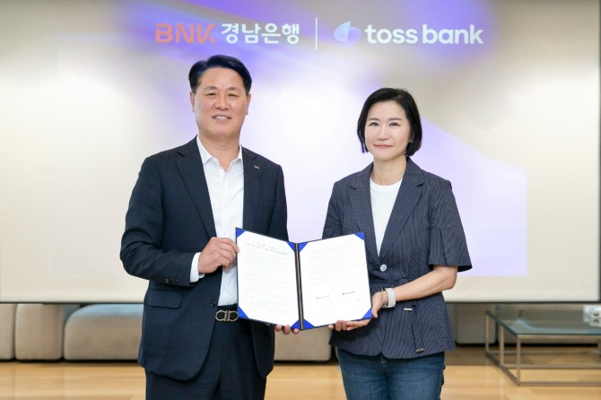 김태한(왼쪽) BNK경남은행장과 이은미 토스뱅크 행장이 11일 서울 강남구 토스뱅크 본사에서 열린 ‘공동 상품 개발 및 상호 혁신을 위한 협약식’에서 기념 촬영을 하고 있다. 사진=경남은행