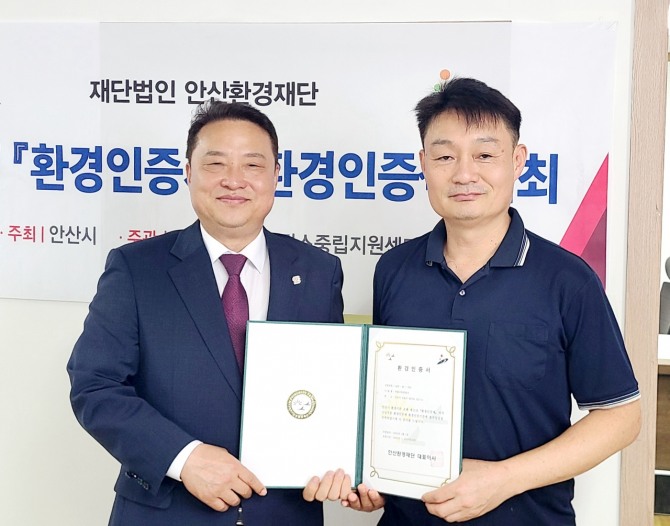 지난 13일 안산환경재단 홍희관 대표이사(왼쪽)가 부흥금속공업사에 환경인증제 블루등급 인증서와 현판을 수여하고 있는 모습. 사진=안산환경재단