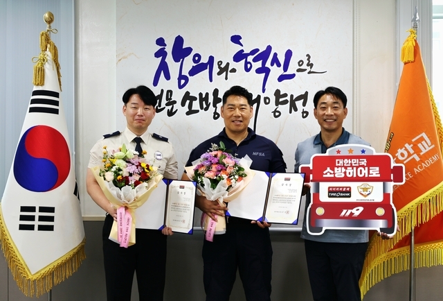 타이어뱅크가 지난 27일 충남 공주시에 위치한 중앙소방학교에서 소방히어로 38호와 39호에게 감사장을 전달했다. 사진은 소방히어로 38호 송영욱(왼쪽) 소방위와 39호 정제우(가운데) 소방경, 전국 소방안전공무원노조 소방청본부의 김종한 위원장이 기념촬영을 하고 있다. 사진=타이어뱅크
