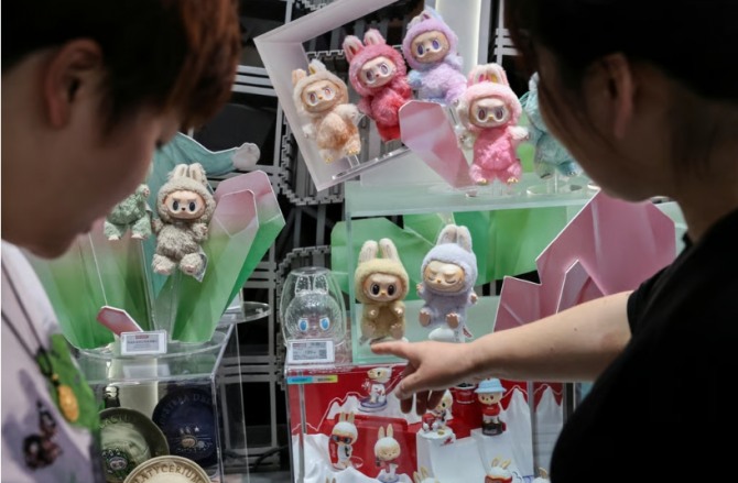 2025년 6월 13일 상하이에 있는 팝마트 플래그십 스토어에서 쇼핑객들이 라부부 인형을 둘러보고 있다. 사진=로이터
