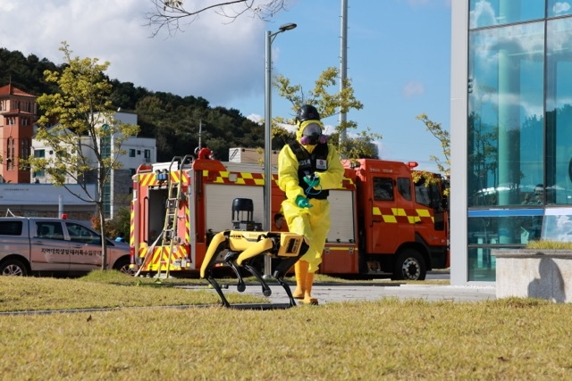 한국가스안전공사 직원들과 로봇개가 24일 진천군 진천종합스포츠타운에서 열린 '2025년 안전한국훈련'에서  독성가스 누출 재난현장으로 진입하고 있다. 사진=한국가스안전공사 
