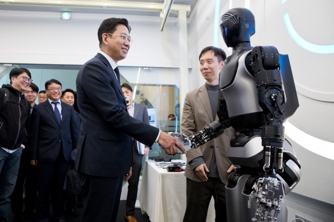 배경훈 부총리 겸 과학기술정보통신부 장관이 지난 11월 서울 성북구 한국과학기술연구원(KIST)을 방문해 이종원 KIST 휴머노이드연구단장으로부터 AI 휴머노이드 로봇인 'KAPEX'에 관한 설명을 듣고 'KAPEX'와 악수하고 있다. 사진=뉴시스