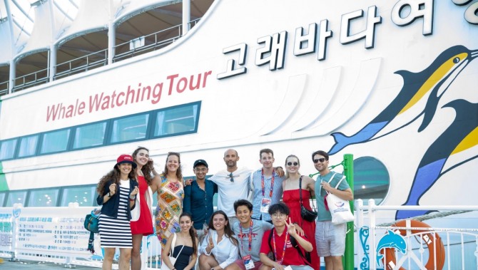 2025 울산 세계명문대학 조정 페스티벌 참가 선수들이 울산 고래바다여행선 앞에서 기념촬영을 하고 있다. 세계 명문대 선수단은 조정 경기와 함께 울산의 주요 관광지와 산업현장을 둘러보는 울산투어 프로그램에도 참여했다. 사진= 울산시